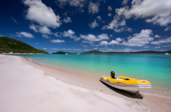 The inviting Chalkies Beach in the Whitsundays has turquoise blue waters, and coral just offshore.