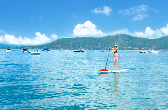 A woman goes stand-up paddleboarding on Lake Tahoe in the US.