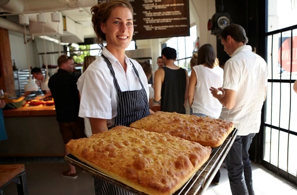  A waitress holds bread fresh from the oven at Railtown Café.