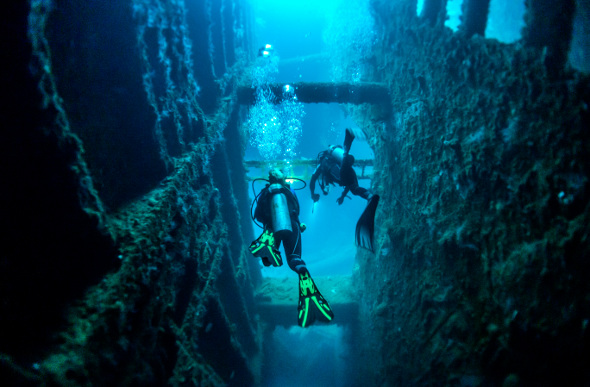 Two divers explore the wreck of the SS President Coolidge in Vanuatu.