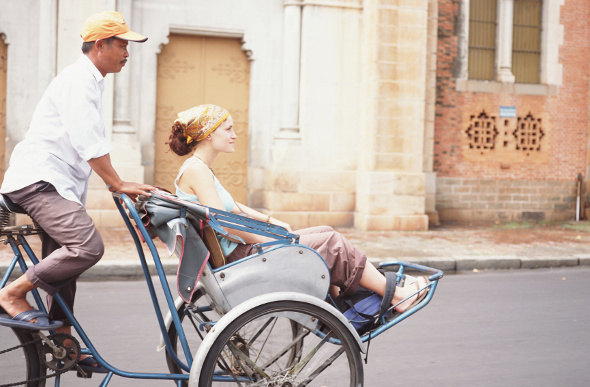 A young woman rides a cyclo in Ho Chi Minh City.