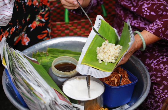 A woman serves street food in Ho Chi Minh City, Vietnam.