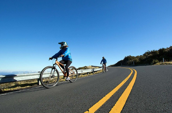Cyclists ride down Haleakala in Hawaii.