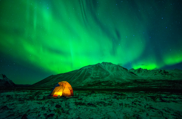 A tent under the northern lights in Yukon