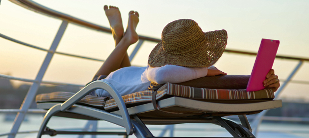 Woman reading in sun lounger on cruise