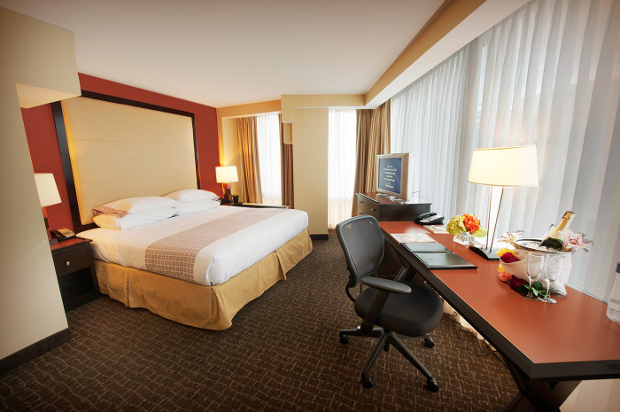A view of Beacon hotel room looking at the bed and work desk