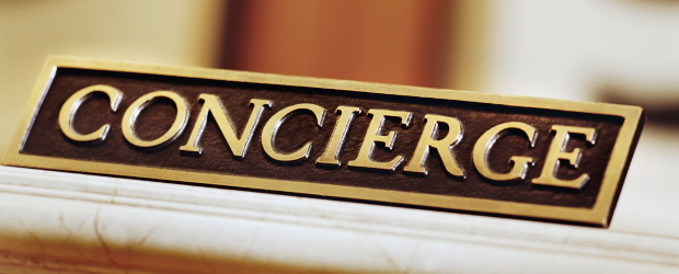 A concierge name plate sitting on a desk