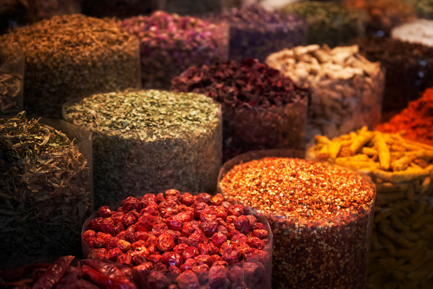 Rows of containers at the market containing colourful spices