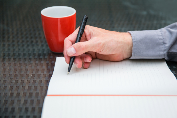 A man writes in his journal.