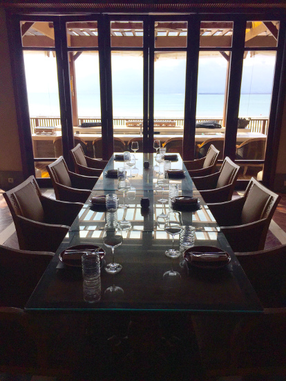 Overlooking the dining area of a Four Season's villa out to the balcony and on to the ocean