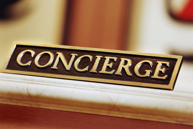 A concierge sign sitting on a desk