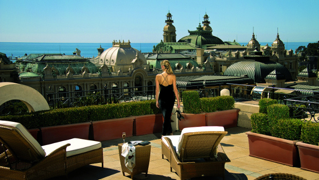 A woman enjoying a view of Monaco from the top of the Hotel Monaco
