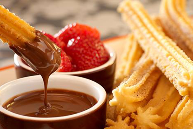 Churros dipped in hot chocolate.