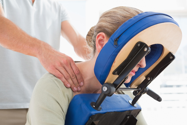 A woman getting a massage in a massage chair
