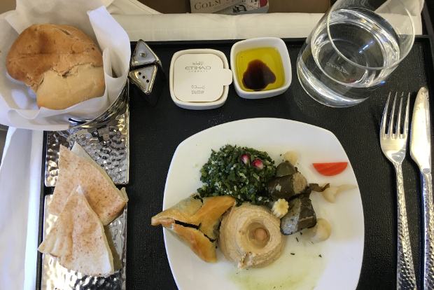 Looking at a mezze plate with various dips and breads