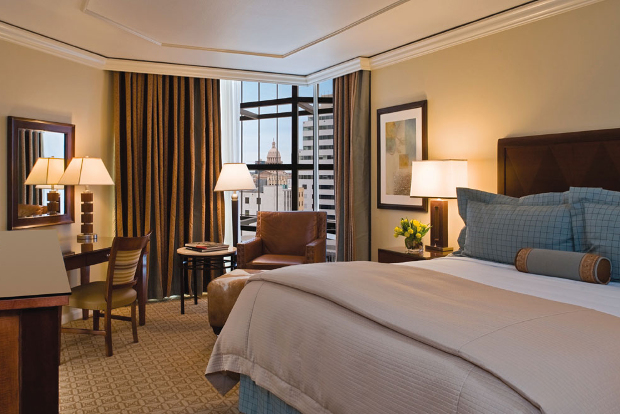 The interior of one of the rooms of the Omni Austin hotel looking out to the surrounding city