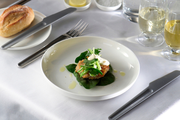 A plate of food with silverware and drinks