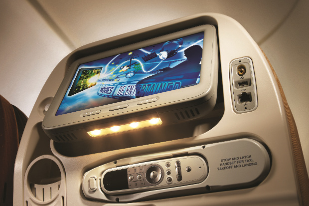 A seatback entertainment screen in economy class