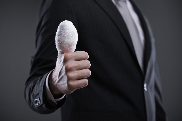 A businessman with a bandaged thumb.