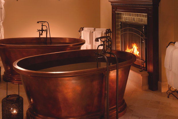 The Serenity Suite at Spa Montage Deer Valley features two copper bathtubs by a fireplace.