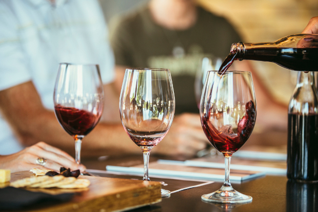 A person pouring a glass of wine