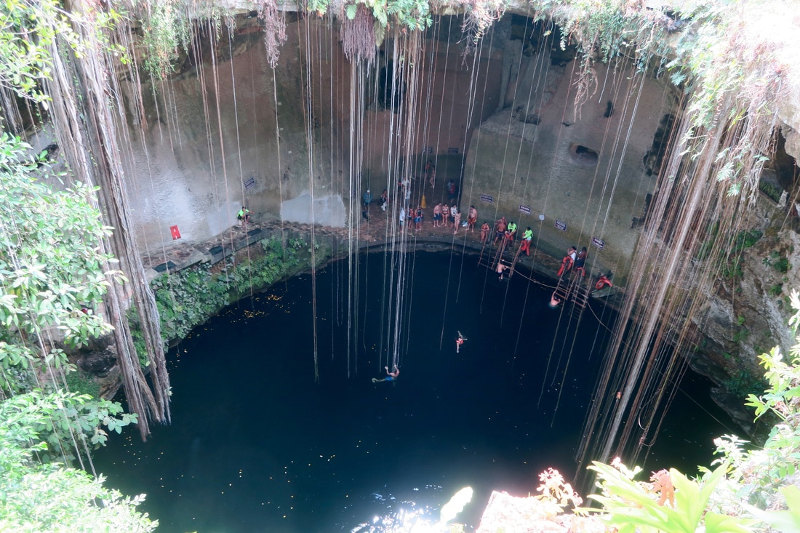 People enjoy a dip in a cenote (waterhole) in Tulum, Mexico.