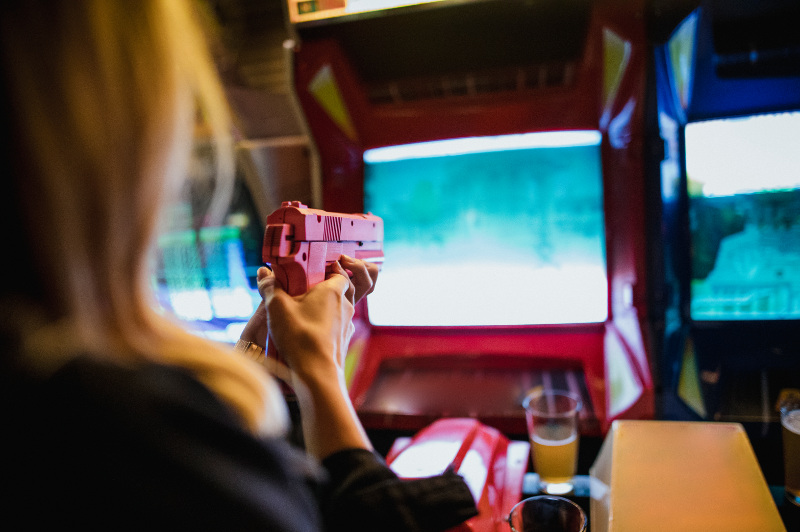 Woman playing arcade game