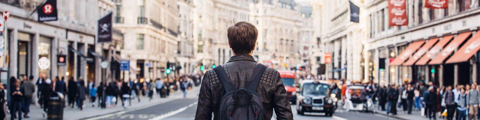 man standing in london street facing away