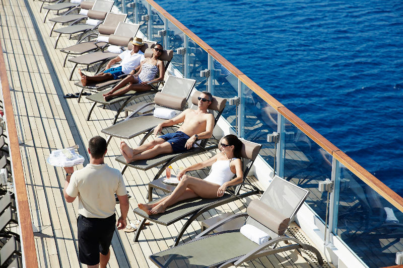 Cruise passengers relaxing on deck of a luxury ship