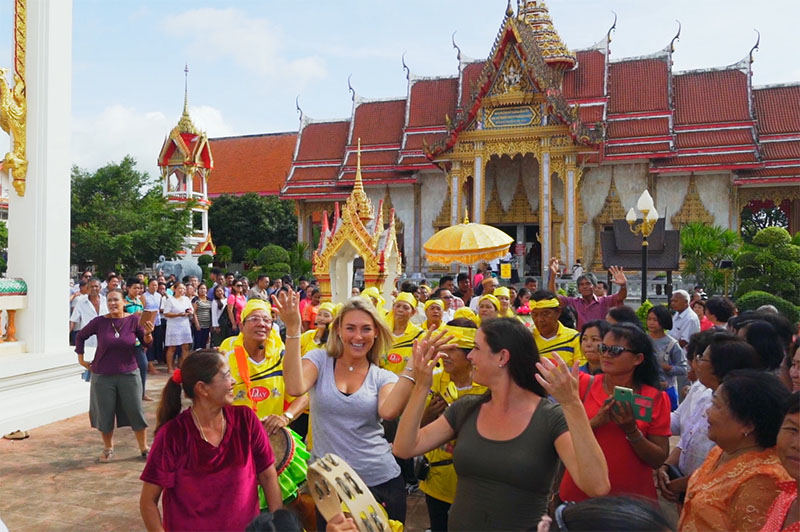 greer and rhi dancing with locals at wat chalong temple