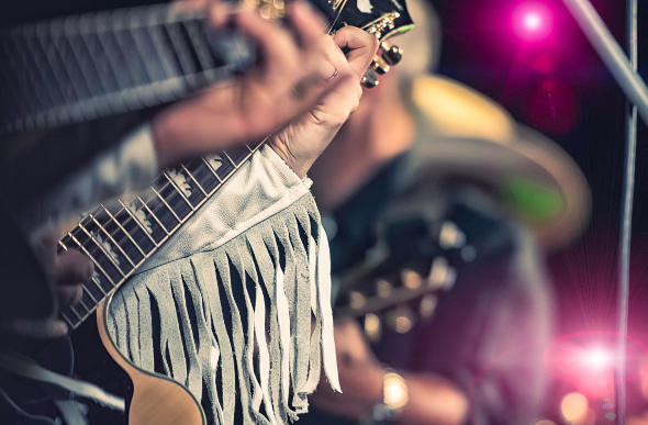 A close-up of a country music guitarist.
