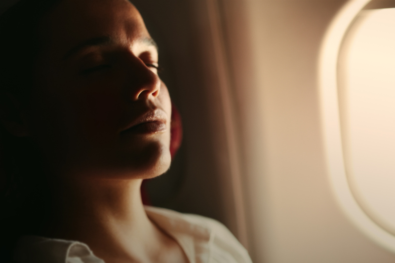 A woman sleeping on the plane