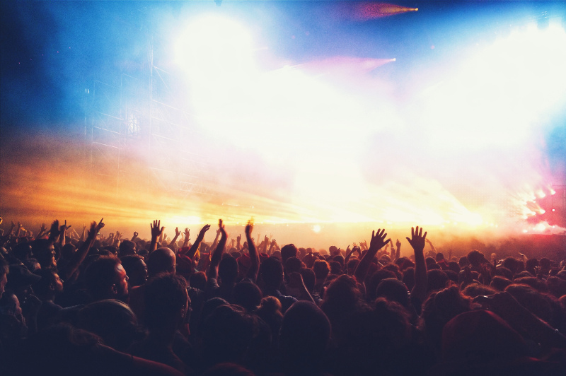 A dancing crowd at an outdoor music festival.