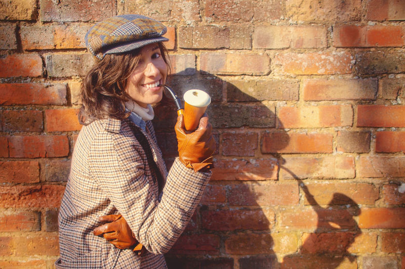 A woman in a Sherlock Holmes outfit.