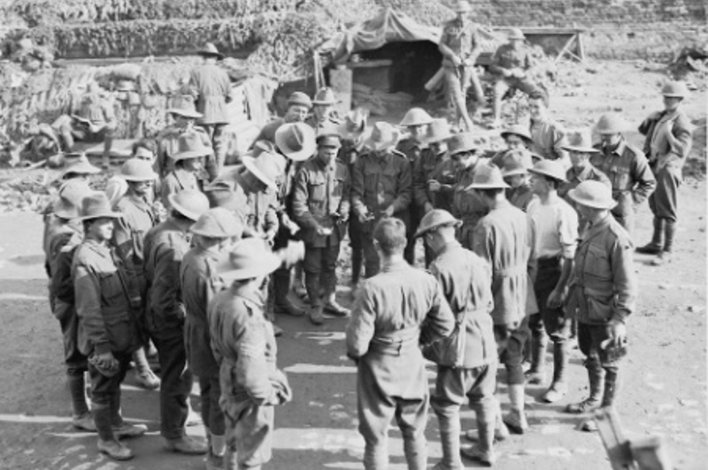 Australian soldiers play two-up during World War I at the front near Ypres, December 23, 1917. Image: Wikipedia/Australian War Memorial Museum