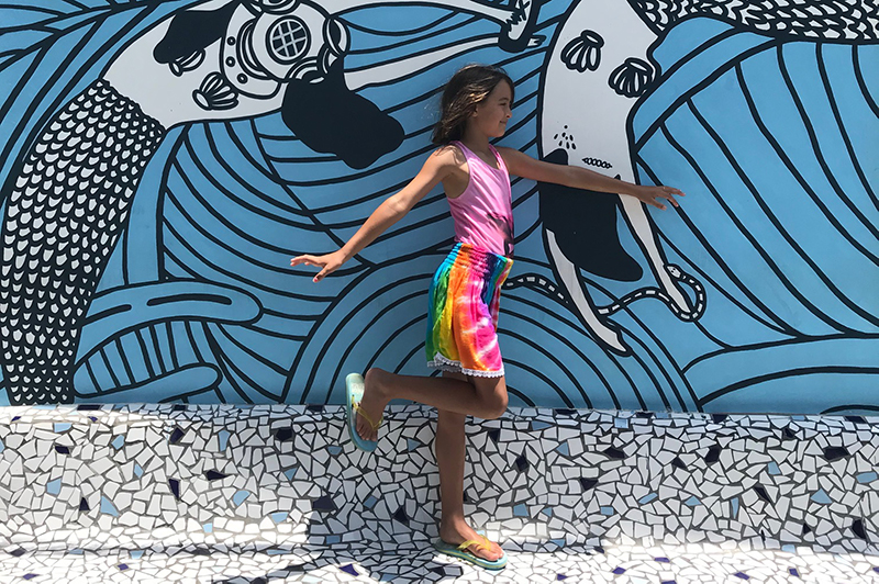 Girl in front of mural in Canggu.