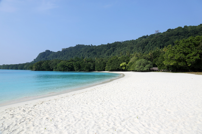 The white sand, turquoise waters and jungle-covered hills of Champagne Beach in Vanuatu.