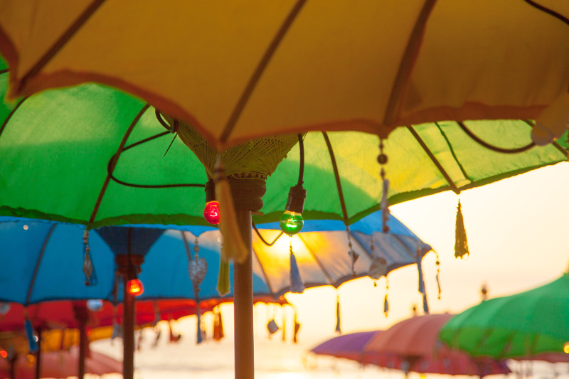 Beach umbrellas and lights at a beach bar in Kuta, Bali.