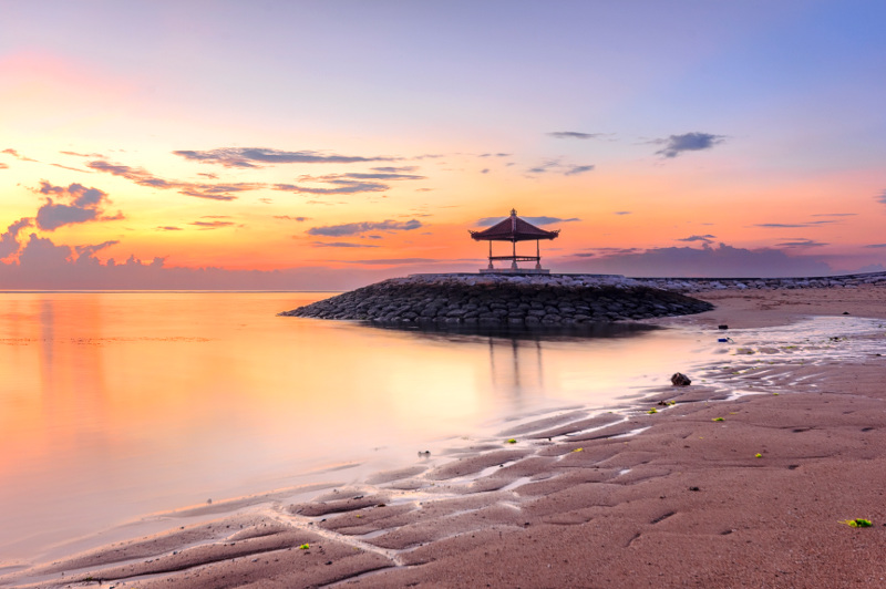 A Balinese pagoda graces the shore at Sanur Beach. Image: Getty
