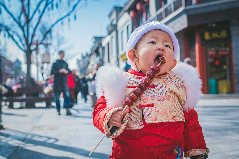 Boy eating in Beijing street