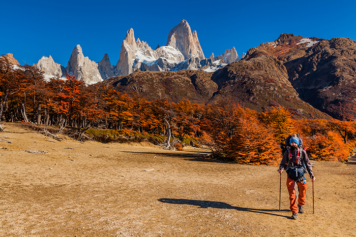A walker in the foreground with El Chatan peak in the background in Patagonia