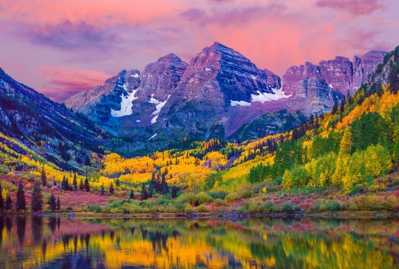 Image overlooking a lake with colourful trees in the background