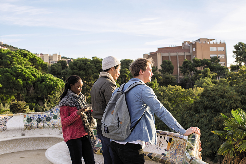 travellers at parc guell lookout in barcelona