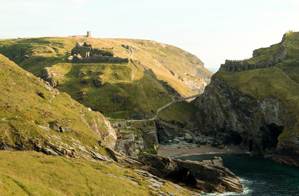 The ruins of Tintagel Castle sprawl across the Cornish hillside.