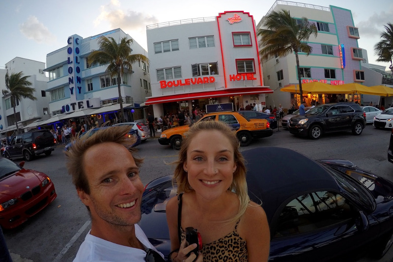 Nick and Meg Wall with the Art Deco hotels of Miami Beach in the background.