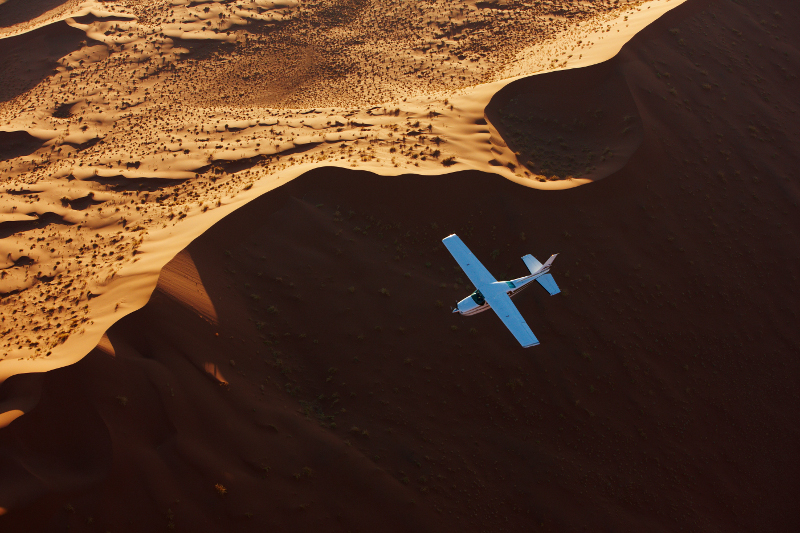 Plane flying over dunes in Namibia.
