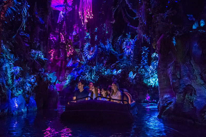 guests cruise through the na'vi river on the pandora ride at walt disney world