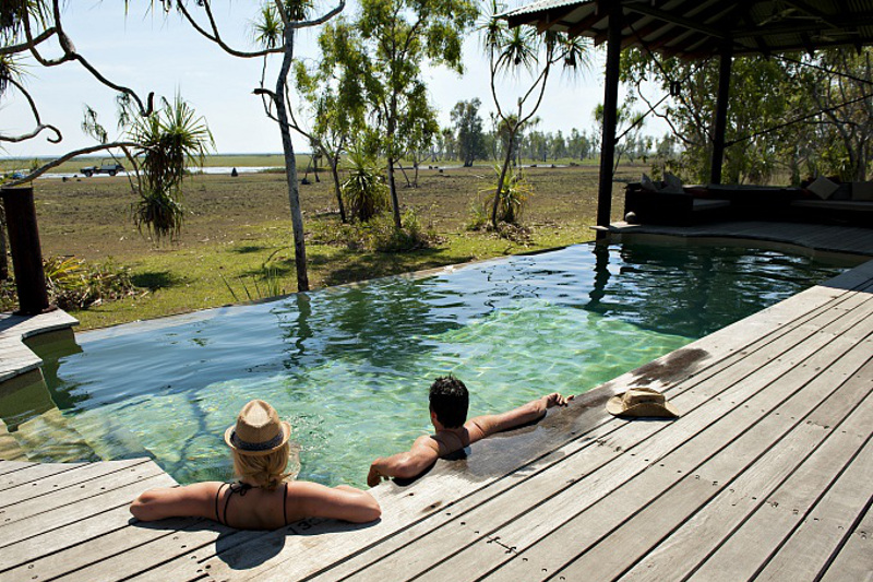 A couple in a stylish pool at Bamurru Plains Lodge, on the edge of Kakadu National Park.