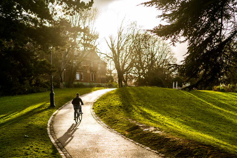 Boy cycling in Parc des Buttes-Chaument, Paris.