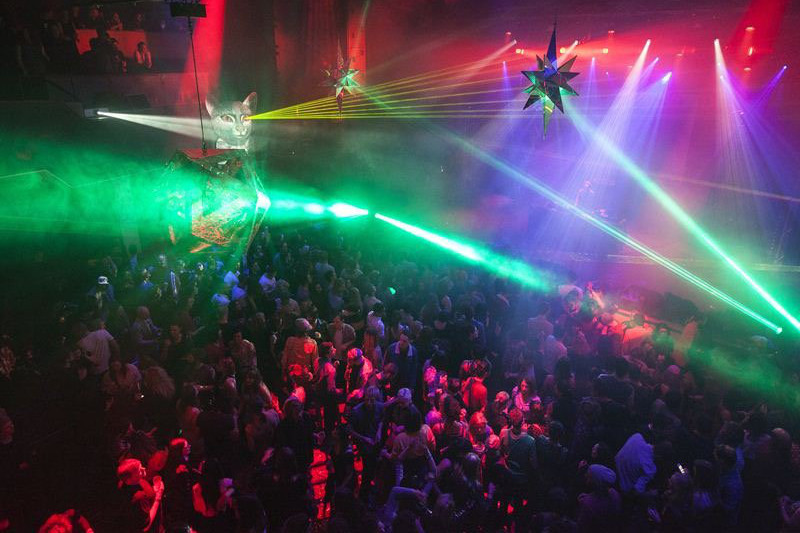 Rave with bright laser lights and people dancing at Dark MOfo festival in Hobart.